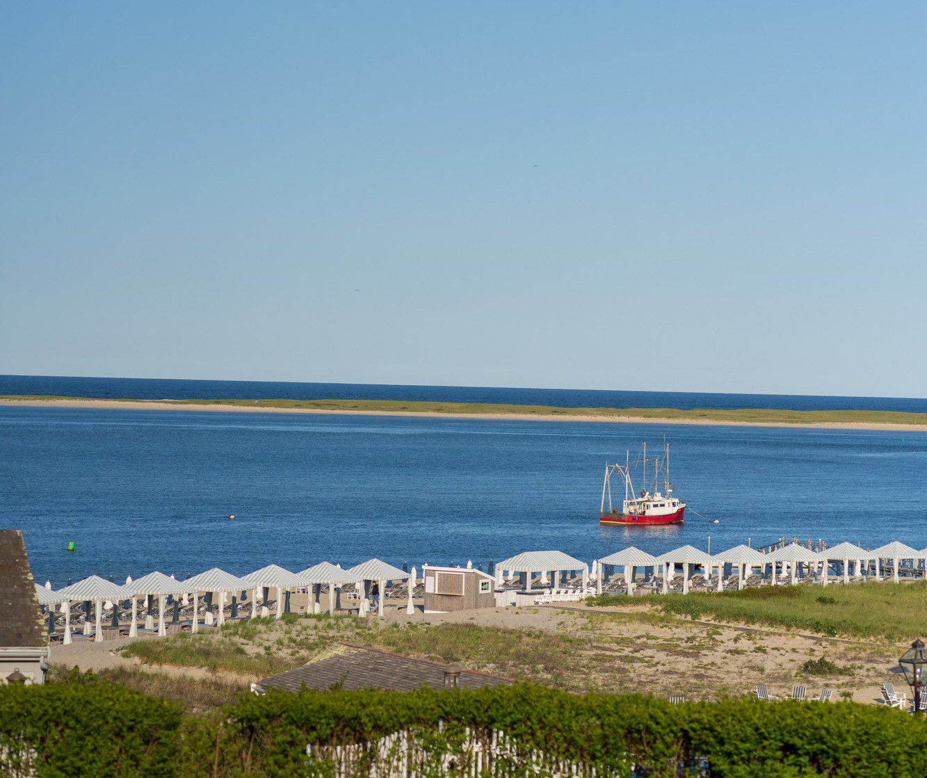 Cape Cod beach cabanas and red lobster boat